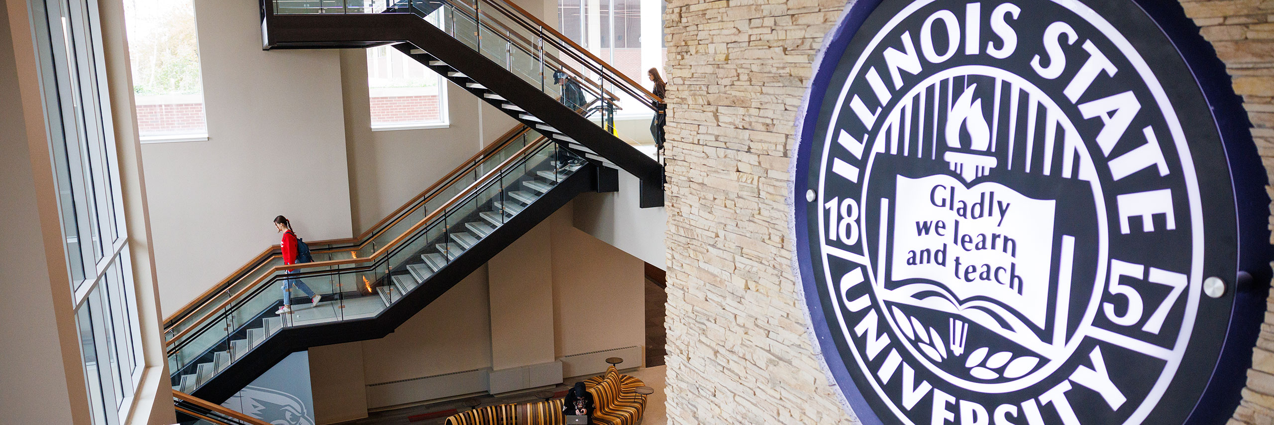 Interior view of the Bone Student Center with a staircase and Illinois State University emblem.